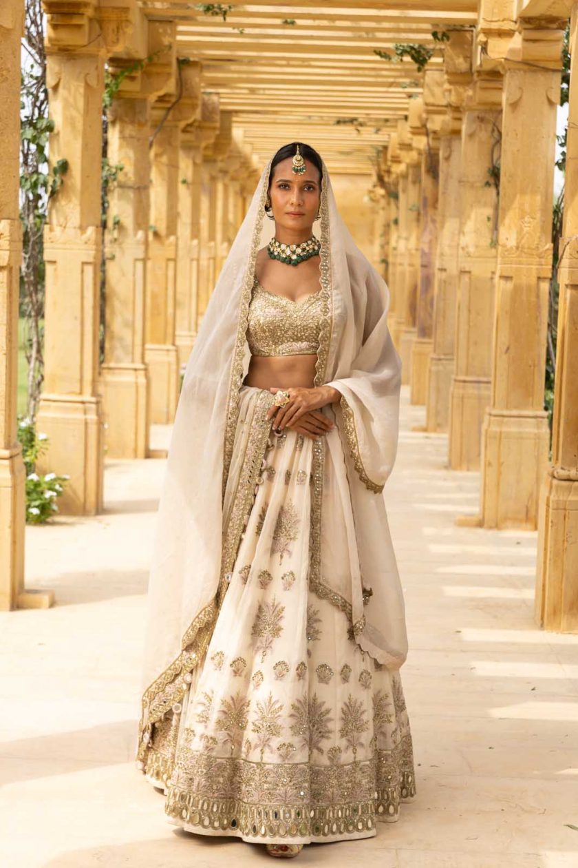 Coconut and gold hand embroidered lehenga set.