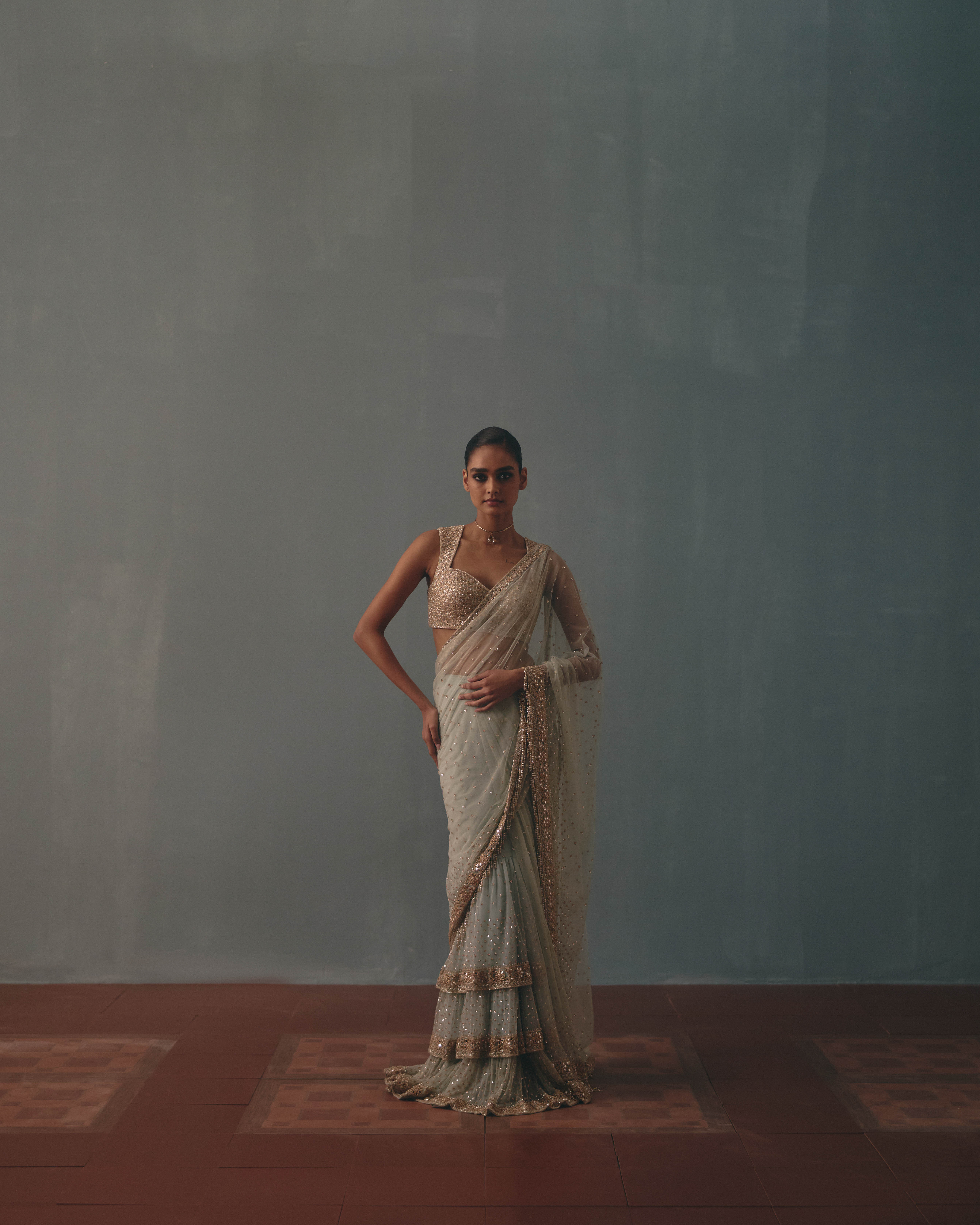 Ice blue & rose gold hand embroidered tiered net sari set